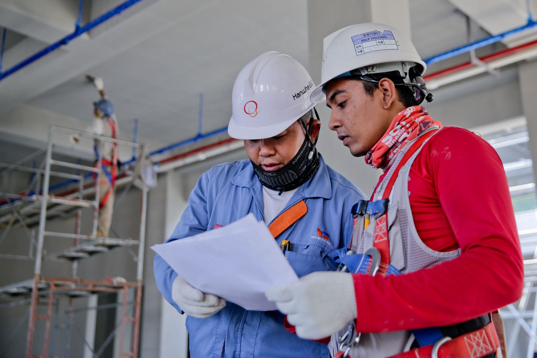 Builders reviewing construction plans together on site
